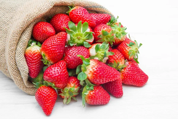 Canvas sack full of  red strawberry — Stock Photo, Image