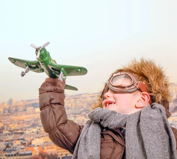 Young aviator  playing with toy airplane — Stock Photo, Image