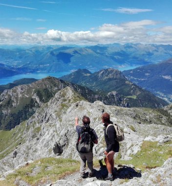 hikers lloking the panorama of the lake of Como and lecco and re clipart