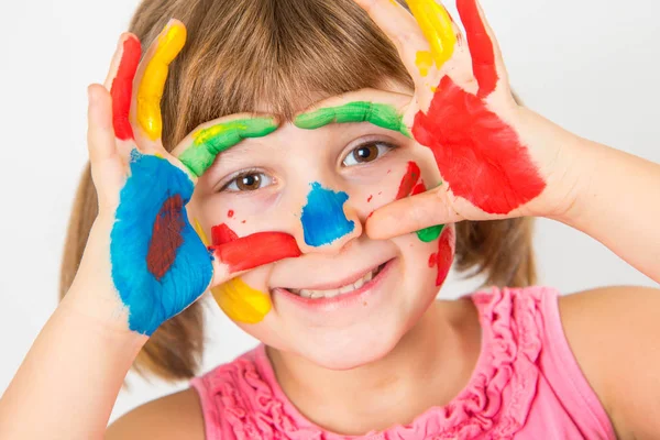 Smiling little girl with hands painted in colorful paints — Stock Photo, Image