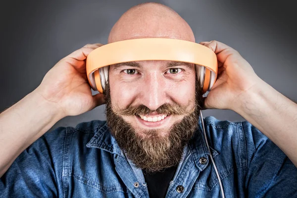 expressive man listen music with headphone