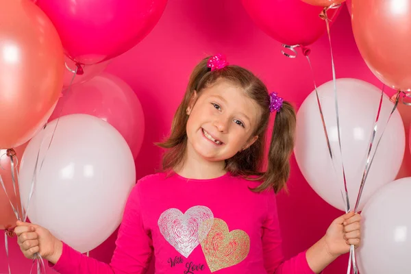 Ομορφιά κορίτσι με πολύχρωμα μπαλόνια αέρα χαμογελώντας πάνω από ροζ backgro — Φωτογραφία Αρχείου