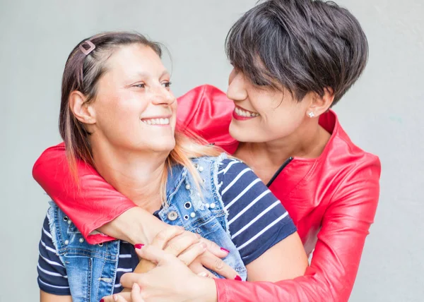 Happy playful girlfriends in love sharing time together — Stock Photo, Image