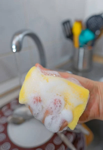 Close up hands of woman washing dishes — Stock Photo, Image