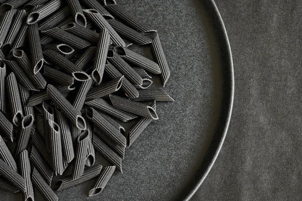 Black bean penne pasta — Stock Photo, Image