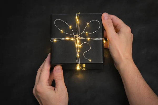 Present Box wrapped with string lights — Stock Photo, Image