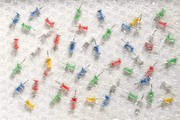 Bubble Wrap and Colored Thumbtacks — Stock Photo, Image