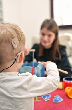 A Boy With Cochlear Implants Playing 