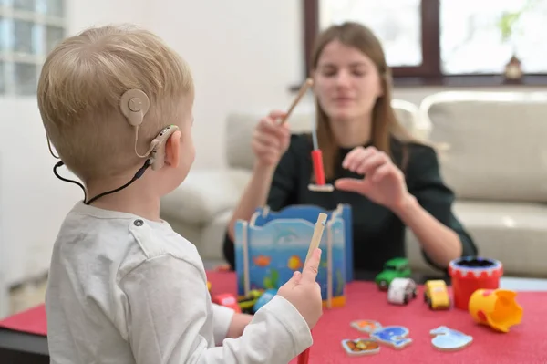 Boy Hearing Aids Cochlear Implants Playing — Stockfoto