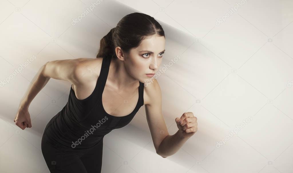 running caucasian woman studio isolated on bg with blur motion 