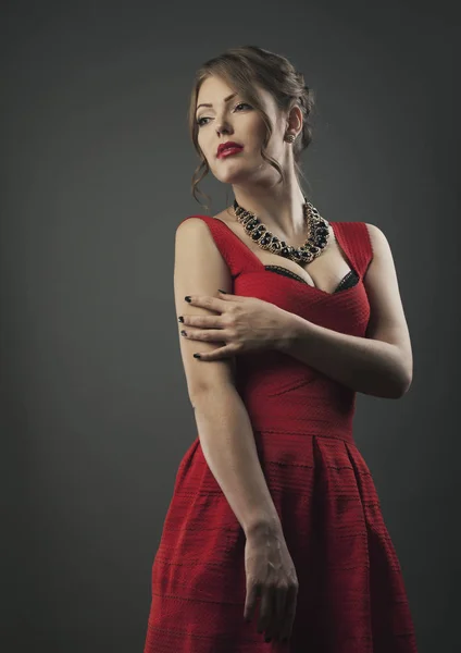 Young beauty in red dress woman studio shot fashion — Stock Photo, Image