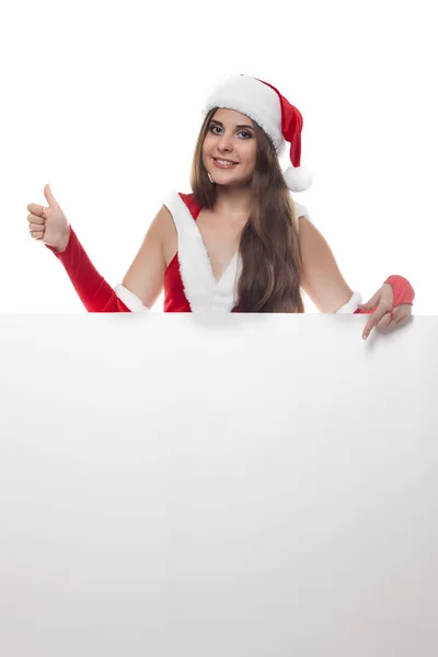 Mujer de belleza en vestido de navidad rojo y sombrero con un billbo vacío —  Fotos de Stock