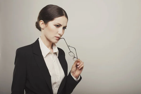 Business woman with glass think studio shot — Stock Photo, Image