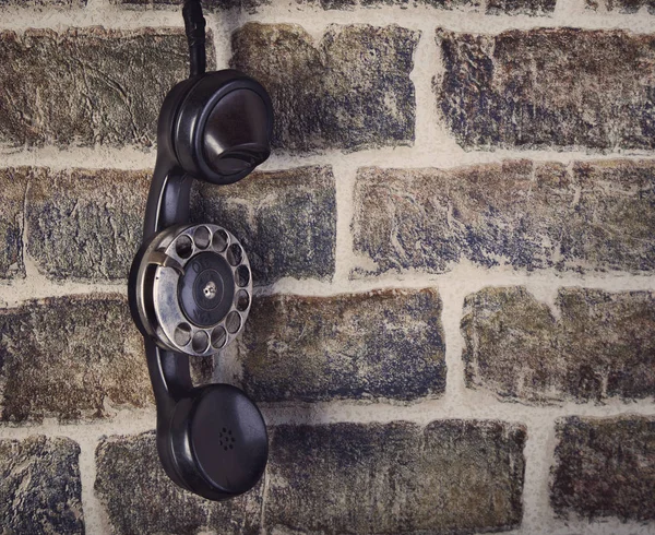 Old phone and wall brick close up — Stock Photo, Image