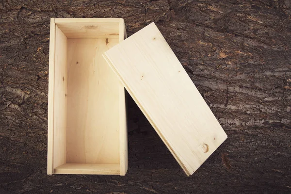 Wooden box on a woooden background opened top view — Stock Photo, Image
