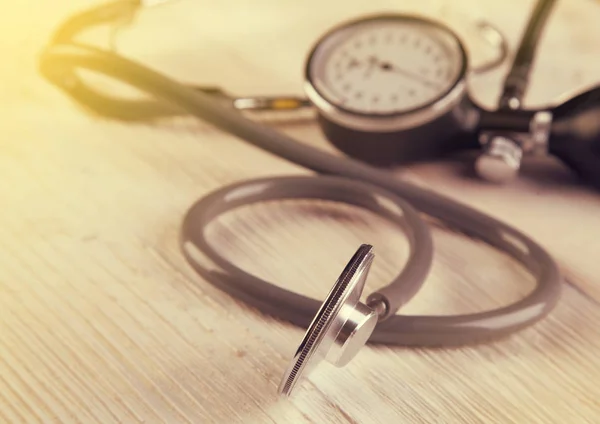 White wooden background with medic Stethoscope in sun light — Stock Photo, Image