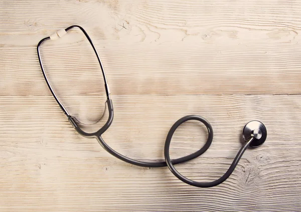 White wooden background with medic Stethoscope — Stock Photo, Image