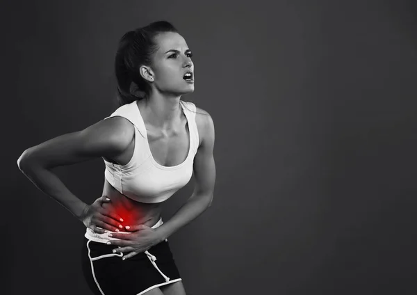 Nő sport fájdalom piros stúdió sötét dg fotó — Stock Fotó