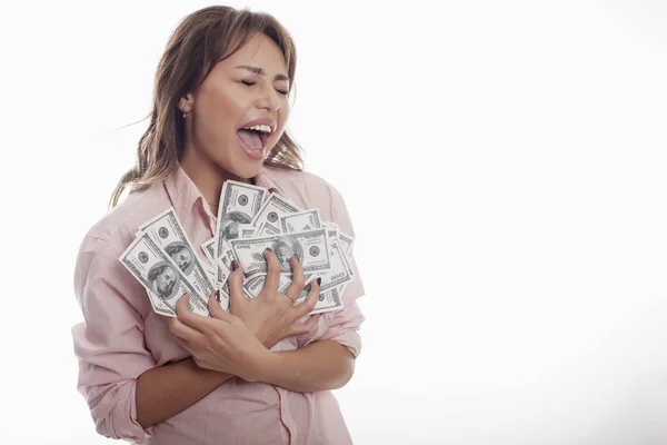 Happy woman holding big money on white bg studio shot — Stock Photo, Image