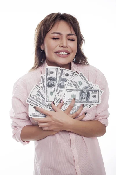 Happy woman holding money on white bg studio shot — Stock Photo, Image