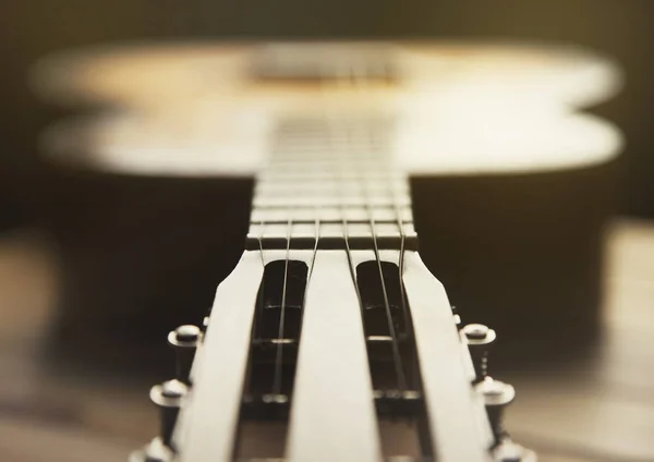 Guitar close up photo blur effect on dark — Stock Photo, Image