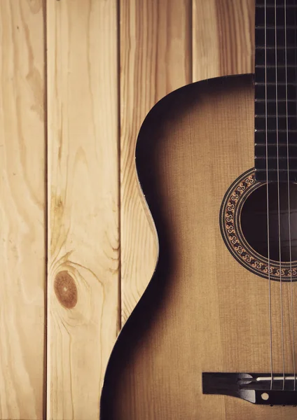 Guitar on a  wooden bg  part photo — Stock Photo, Image