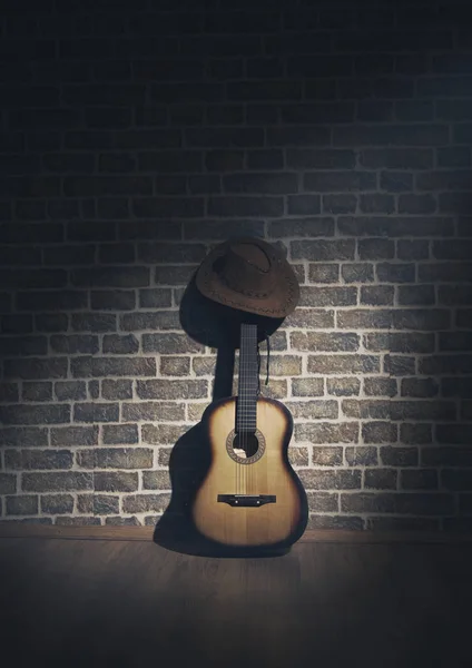 Hat cowboy and guitar and wall  brick light and shadow photo — Stock Photo, Image