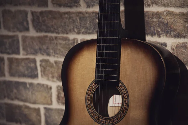 Part guitar and wall  brick light and shadow photo — Stock Photo, Image