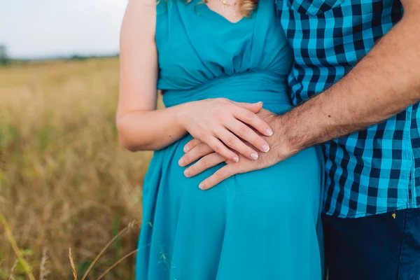 Gros plan main de l'homme sur le ventre de sa femme enceinte — Photo