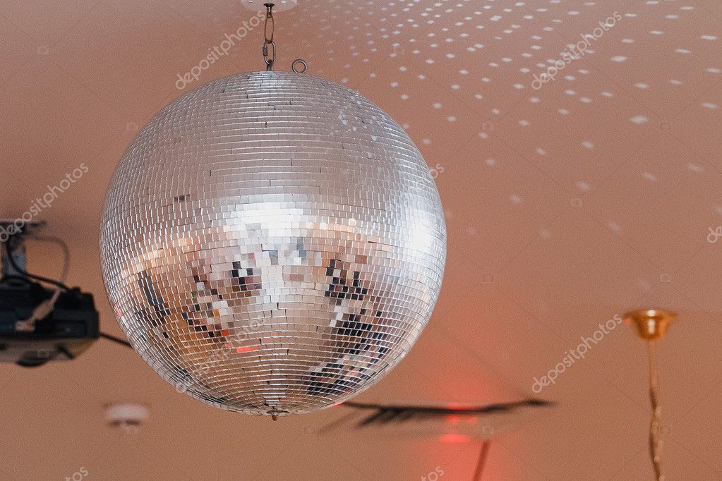 Shining Disco Ball On The Ceiling Of The Restaurant Stock Photo