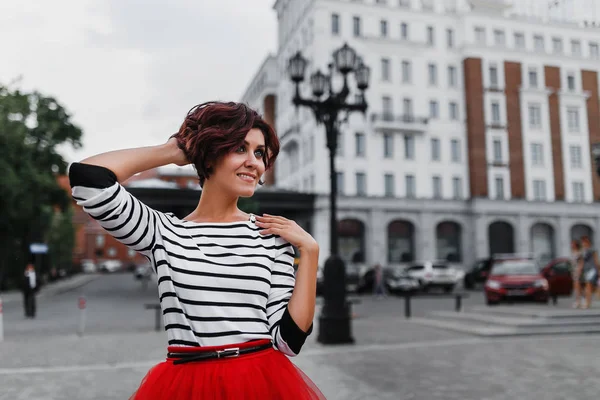 Sensitive woman standing in the city street with urban background of cars and buildings. Love in the city concept — Stock Photo, Image