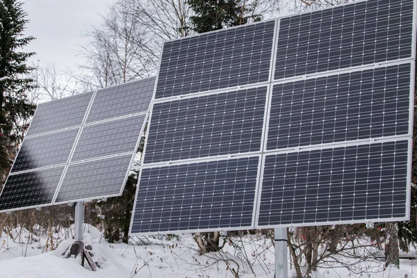 Solar panel plant in cloudy weather in the winter forest