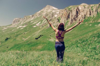 Kadın uzun yürüyüşe çıkan kimse Dağı'nın harika manzarasını kutluyor ellerini kaldırdı