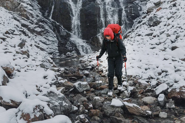 hiker enjoy the leisure time at winter mountains. The trail passes near a large and beautiful waterfall