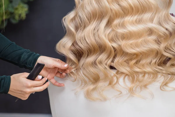 Golden haired blonde doing the Curling by hairdresser in the beauty salon — Stock Photo, Image