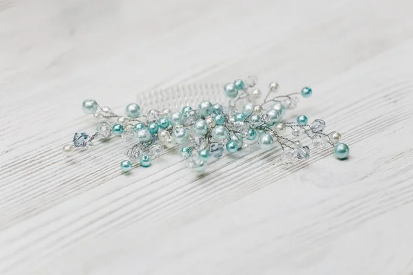 turquoise jewelry diadem for hair on a white wooden background