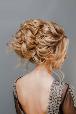 Mükemmel saç modeli ve yaratıcı saç-elbise, arka görünümü ile model sarışın kadın