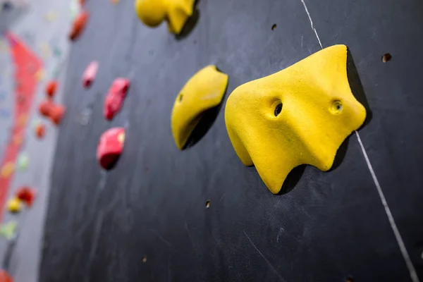 Stone hook on the artificial climbing wall at indoor gym
