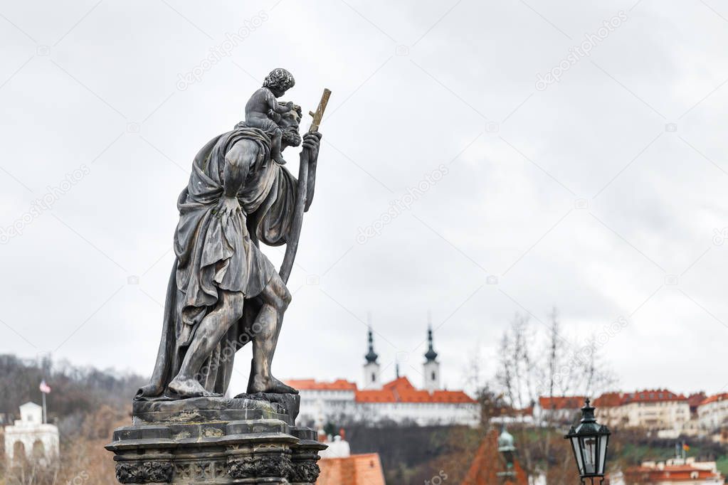 Statue of Child Christus at the shoulder of saint Christopher, Patron of wanderers, navigators and travelers on Charles Bridge, Prague