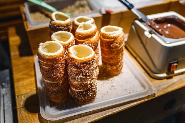 Traditional Czech Trdelnik is a sweet bread shaped like a large hollow cupcakes with sugar and cinnamon — Stock Photo, Image