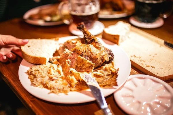 Dinner at the Prague tavern on a dish baked duck with sauerkraut — Stock Photo, Image