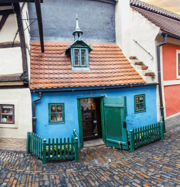 Fairy tale bright colored houses on the famous golden street named Zlata ulicka in Prague's castle clipart