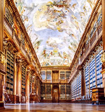 PRAGUE, CZECH REPUBLIC, 19 MARCH 2017: A large colorful philosophical hall in the famous old library of Strahov Monastery with ancient books and manuscripts clipart
