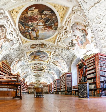 PRAGUE, CZECH REPUBLIC, 19 MARCH 2017: A large colorful theological hall in the famous old library of Strahov Monastery with ancient books and manuscripts clipart