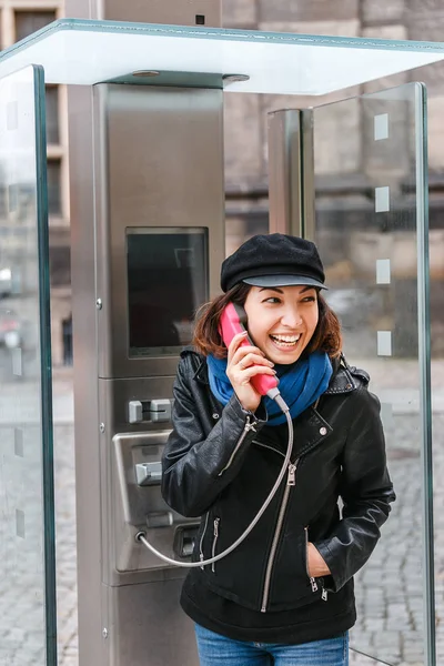 Portrét ženy a turistické mluví v moderní telefonní budky na městě ulici, telefonní spojení během cesty koncept — Stock fotografie