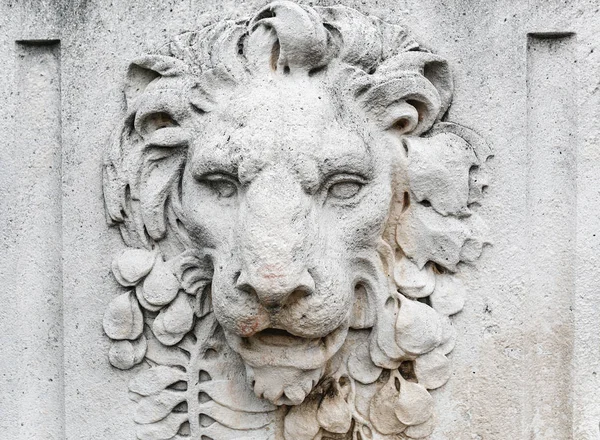 old Lion head relief on the facade