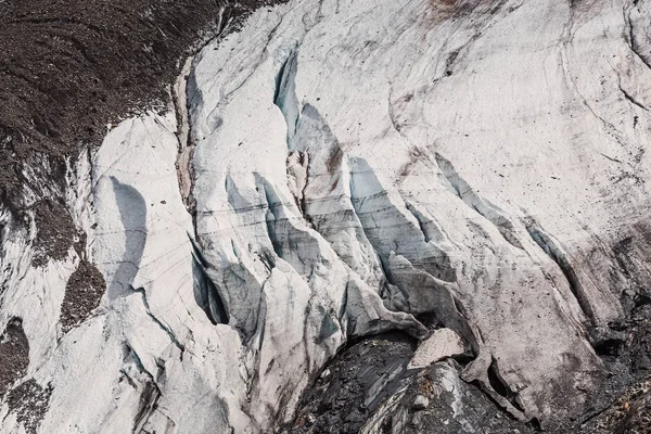 Closeup detail of mountain glacier with rocks Royalty Free Stock Photos