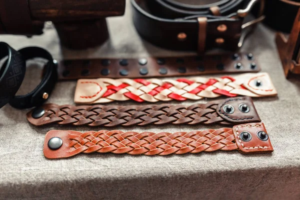 hand made crafts leather bracelets on the sale at the shop with ethno painting