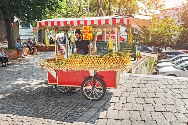11 SEPTIEMBRE 2017, TURQUÍA, ISTANBUL: El vendedor de la tradicional comida rápida turca hervido maíz en una de las atracciones turísticas populares — Foto de Stock