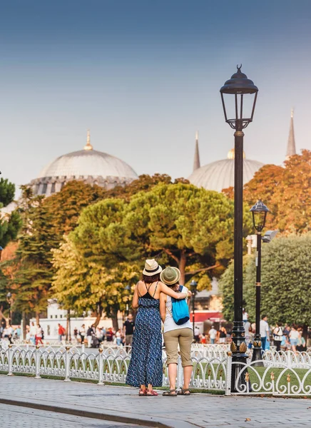 Two happy girls enjoy the breathtaking views of the sights of Istanbul. Concept of friends travel and students in Turkey